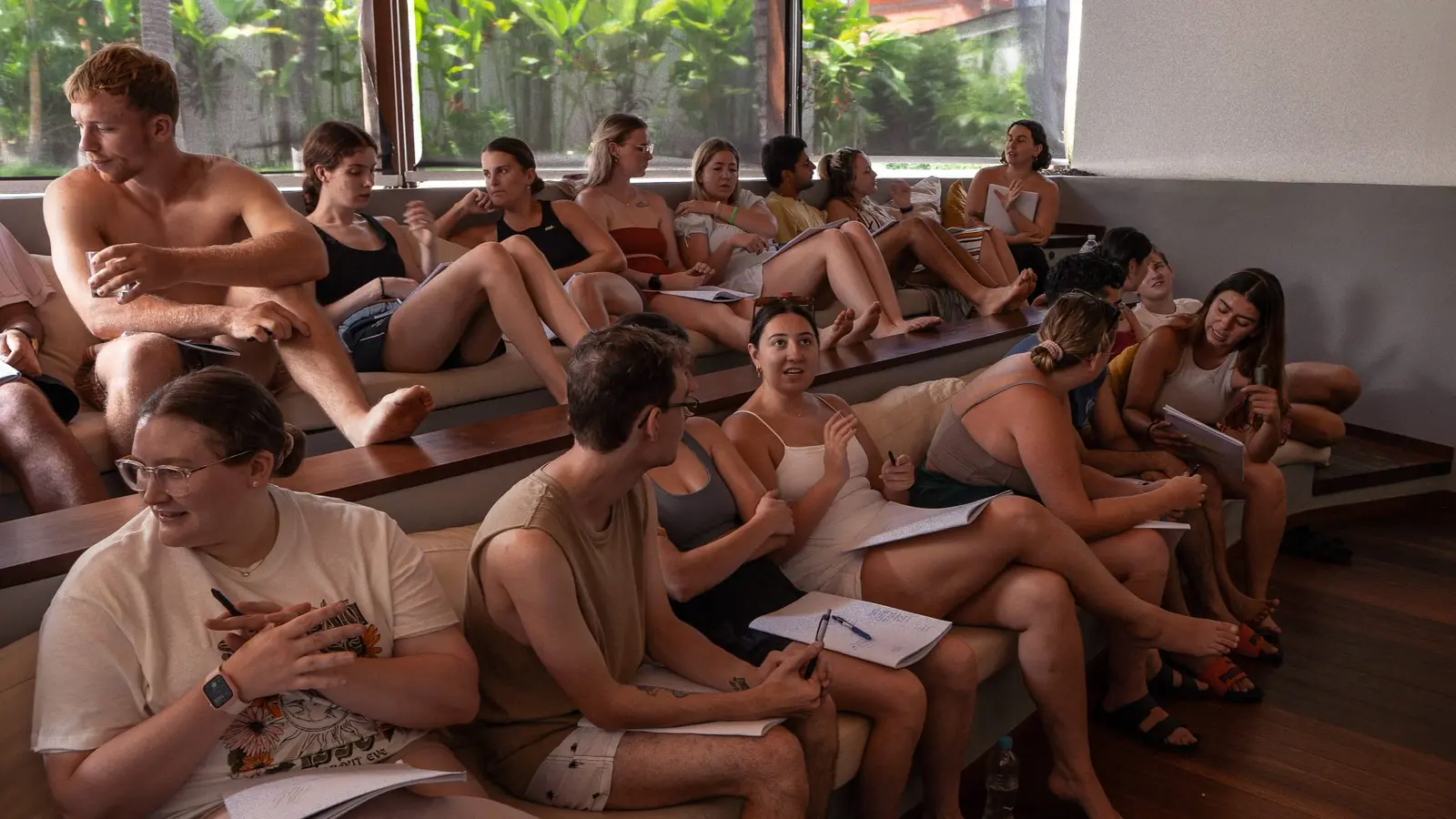 Founders writing in notebooks during a session
